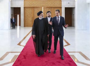 In this photo released by the office of the Iranian Presidency, President Ebrahim Raisi, left, listens to his Syrian counterpart Bashar Assad during a welcoming ceremony in Damascus, Syria, Wednesday, May 3, 2023. (Iranian Presidency Office via AP)