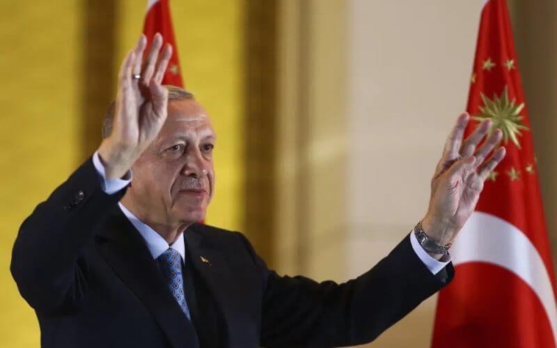 Turkish President and People's Alliance's presidential candidate Recep Tayyip Erdogan gestures to supporters at the presidential palace, in Ankara, Turkey, Sunday, May 28, 2023. (AP Photo/Ali Unal)