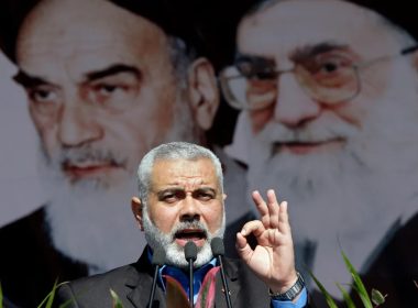 Visiting Hamas prime minister from Gaza, Ismail Haniyeh, gestures as he delivers his speech in front of portraits of late Iranian revolutionary founder Ayatollah Khomeini, left, and supreme leader Ayatollah Ali Khamenei, at a rally in Tehran, on Saturday, Feb. 11, 2012. AP