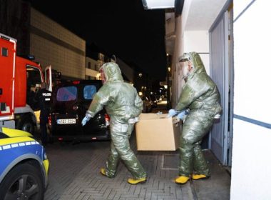 Men in protective suits carry a cardboard box out of a house in Castrop-Rauxel during an anti-terror operation on Jan. 8, 2023. (7aktuell.de, Marc Gruber/dpa via AP, File)