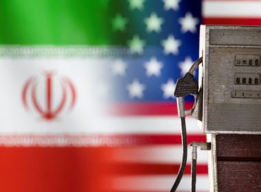 Model of petrol pump is seen in front of U.S. and Iran flag colors in this illustration taken March 25, 2022. REUTERS