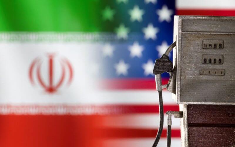 Model of petrol pump is seen in front of U.S. and Iran flag colors in this illustration taken March 25, 2022. REUTERS