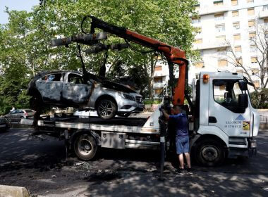 A car, burnt during clashes between youths and police, is removed from the street the day after the death of a 17-year-old teenager killed by a French police officer during a traffic stop, in Nanterre, Paris suburb, France, June 28, 2023. REUTERS