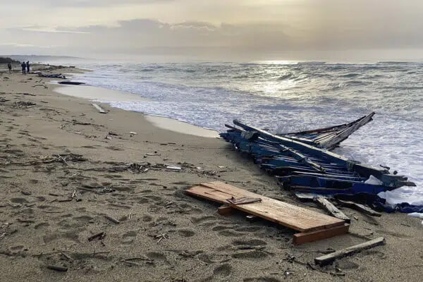 A view of part of the wreckage of a capsized boat that was washed ashore at a beach near Cutro, southern Italy, on Feb. 27, 2023. (AP Photo/Paolo Santalucia, File)