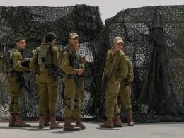 Israeli soldiers gather in front of a gate of military base following a deadly shootout in southern Israel along the Egyptian border, Saturday, June 3, 2023. (AP Photo/Tsafrir Abayov)