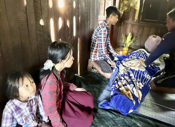 Family members mourn a victim of what they say was shelling by Myanmar army, in Mobye, in Myanmar's Shan State, Saturday, June 10, 2023. (Free Burma Rangers via AP)