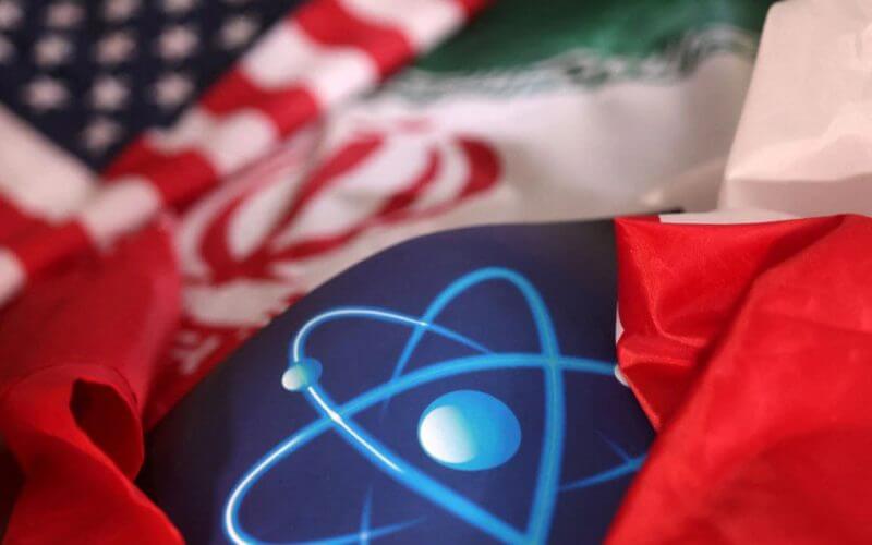 Atomic symbol and USA and Iranian flags are seen in this illustration taken, September 8, 2022. REUTERS