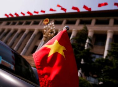The Vietnamese national flag flies on a diplomatic car outside the Great Hall of the People in Beijing, China, May 12, 2017. REUTERS