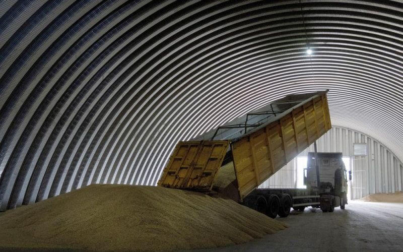 A dump track unloads grain in a granary in the village of Zghurivka, Ukraine, on Aug. 9, 2022. (AP Photo/Efrem Lukatsky, File)