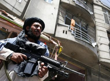 A Taliban fighter stands guard at the site where an explosive-laden vehicle detonated amidst an attack on a Sikh Temple in Kabul, Afghanistan, June 18, 2022. REUTERS