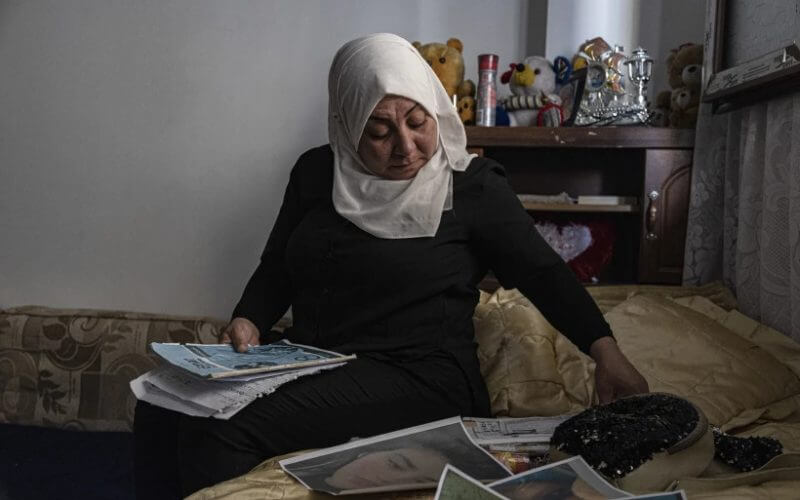 Hamrin Alouji, the mother of 13-year-old Peyal Aqil, goes through her daughter’s photographs at their family home in Qamishli, Syria, on Monday, June 5, 2023. (AP Photo/Baderkhan Ahmad)