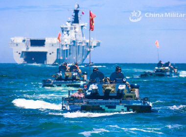 Amphibious armored vehicles attached to a brigade of the PLA Navy's Marine Corps make their way to the beach-head during a maritime offense and defense training exercise recently. Photo:China Military