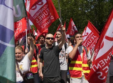 Demonstrators march holding French labour unions flags in Paris, France, Tuesday, June 6, 2023. (AP Photo/Michel Euler)