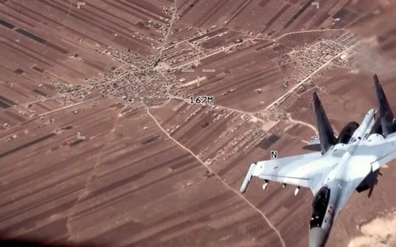 In this image from video released by the U.S. Air Force, a Russian SU-35 flies near a U.S. Air Force MQ-9 Reaper drone on July 5, 2023, over Syria. AP