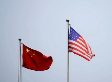 Chinese and U.S. flags flutter outside a company building in Shanghai, China April 14, 2021. REUTERS