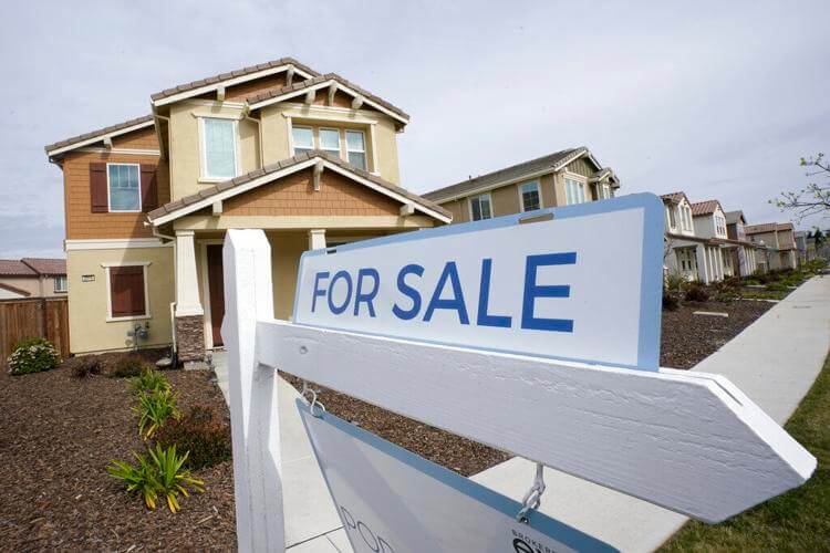 A "for sale" sign is posted in front of a home in Sacramento, Calif., March 3, 2022. Rich Pedroncelli / AP Photo