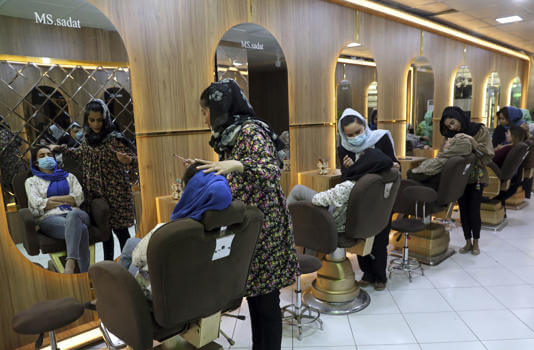 Beauticians put makeup on customers at Ms. Sadat's Beauty Salon in Kabul, Afghanistan, Sunday, April 25, 2021. (AP Photo/Rahmat Gul, File)