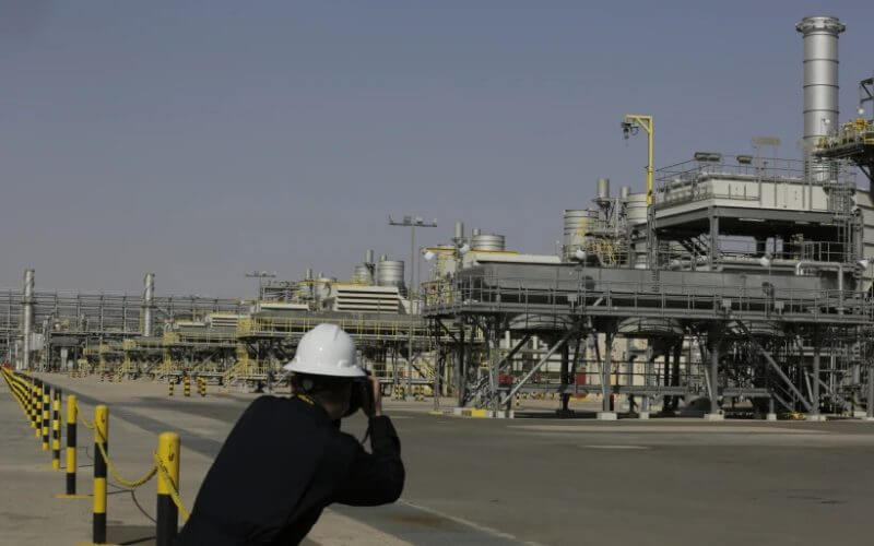 A photographer takes pictures of the Khurais oil field during a tour for journalists, 150 km east-northeast of Riyadh, Saudi Arabia, on June 28, 2021. (AP Photo/Amr Nabil)