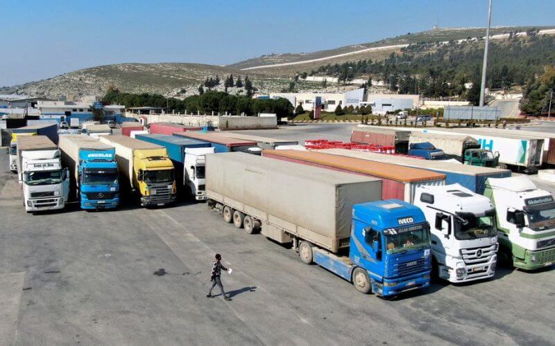 Trucks carrying aid from UN World Food Programme (WFP), following a deadly earthquake, are parked at Bab al-Hawa crossing, Syria February 20, 2023. REUTERS