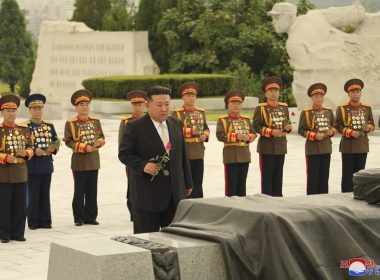 In this photo provided by the North Korean government, North Korean leader Kim Jong Un, foreground, prepares to offer a flower at a liberation war martyrs cemetery in Pyongyang, North Korea Tuesday, July 25, 2023, on the occasion of the 70th anniversary of the armistice that halted fighting in the 1950-53 Korean War. (Korean Central News Agency/Korea News Service/AP)