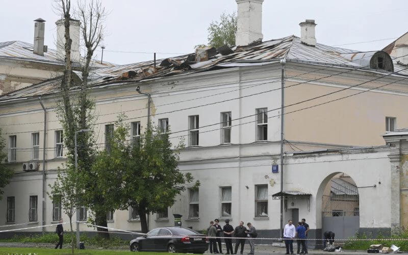 Investigators examine an area next to a damaged building after a reported drone attack in Moscow, Russia, Monday, July 24, 2023. (AP Photo)