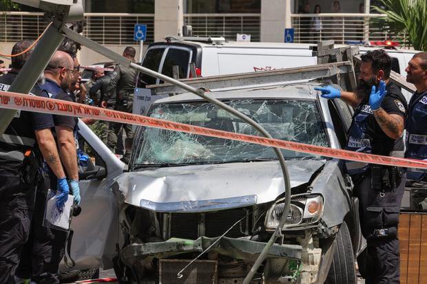 Members of Israeli security and emergency personnel work at the site of a car-ramming attack in Tel Aviv, July 4, 2023. GETTY