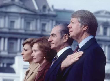 View of, in profile from left, Empress Farah Pahlavi of Iran, First Lady Rosalynn Carter, the Shah of Iran Emperor Reza Palhevi, and President Jimmy Carter as they stand for their respective country's national anthems during a welcoming ceremony at the White House, Nov. 15, 1977. PHOTO BY DIANA WALKER/GETTY IMAGES