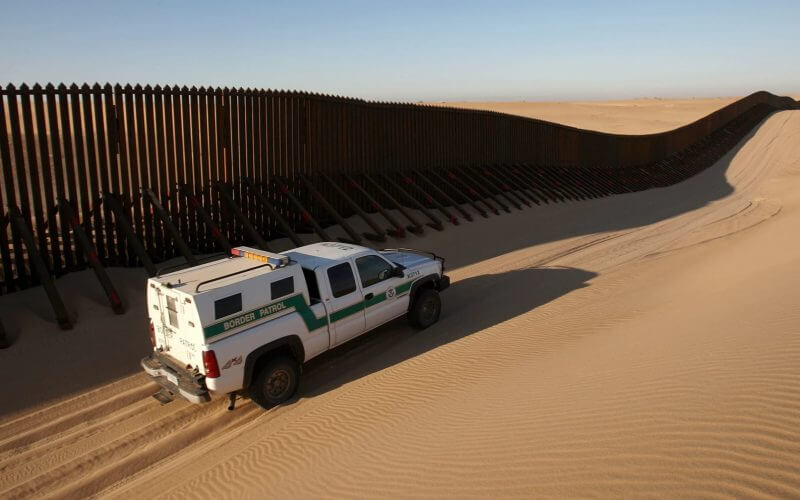 A Border Patrol vehicle patrols a section of the U.S.-Mexico border fence near Yuma, Ariz. David McNew / Getty Images