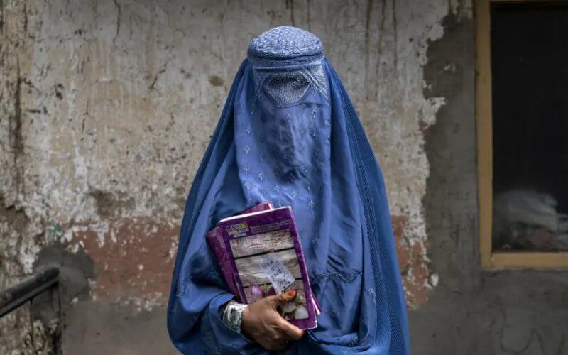 Arefeh 40-year-old, an Afghan woman leaves an underground school, in Kabul, Afghanistan, Saturday, July 30, 2022. (AP Photo/Ebrahim Noroozi)