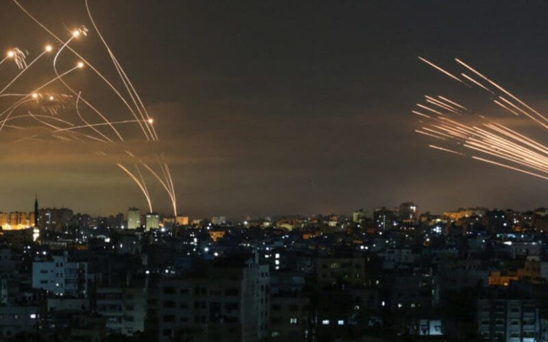 The Israeli Iron Dome missile defense system (L) intercepts rockets (R) fired by the Hamas movement toward southern Israel from Beit Lahia in the northern Gaza Strip as seen in the sky above the Gaza Strip overnight on May 14, 2021. (ANAS BABA/AFP via Getty Images)