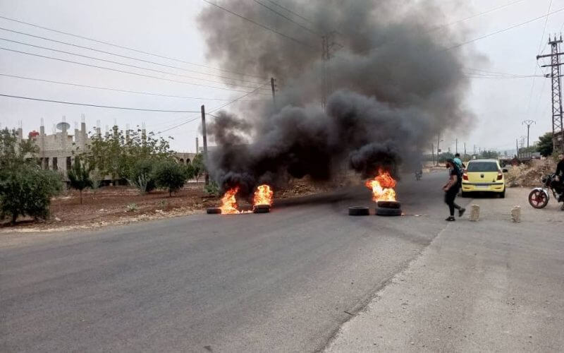 Tires burn as demonstrators protest against the Syrian government decision on increasing the prices of fuels in Sweida, Syria, August 17, 2023. Sweida 24/Handout via REUTERS
