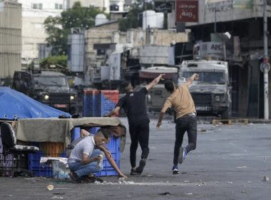 Palestinians clash with Israeli security forces during a military raid in the West Bank city of Nablus, on July 7, 2023. (AP Photo/Majdi Mohammed, File)