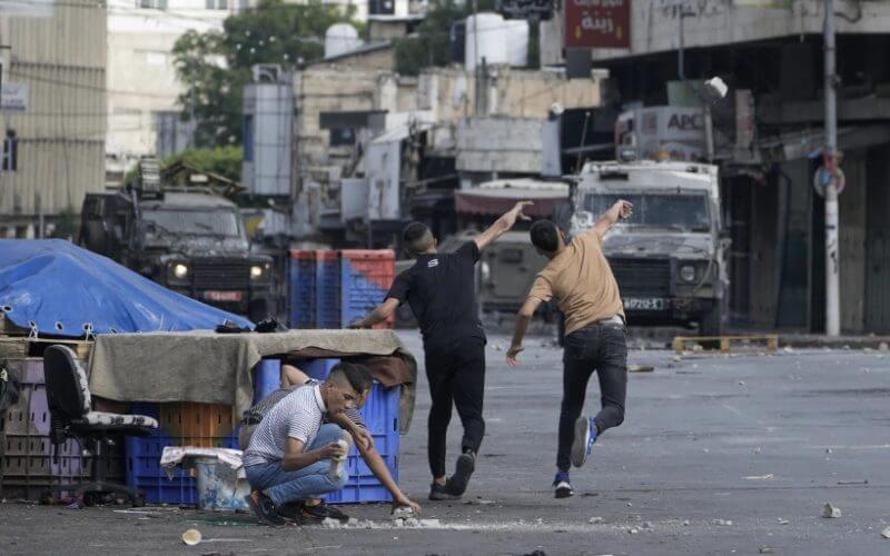Palestinians clash with Israeli security forces during a military raid in the West Bank city of Nablus, on July 7, 2023. (AP Photo/Majdi Mohammed, File)