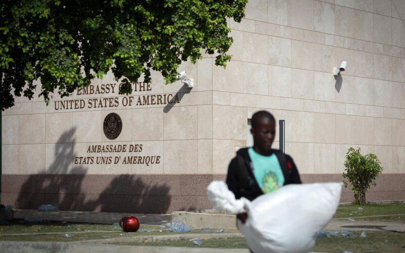 A person walks in front of the United States embassy in Port-au-Prince, Haiti, on July 25. The embassy closed because of gunfire on Tuesday. Photo by Johnson Sabin/EPA-EFE