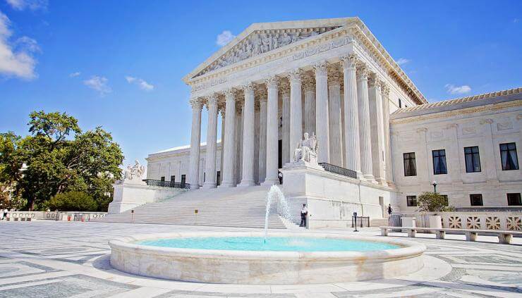 The West Facade of the Supreme Court Building in Washington DC, shows the columned portico of the building with one of its two reflecting pools in the foreground. gcsu.edu