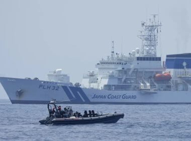 A Philippine Coast Guard rigid hull inflatable boat passes by the Japanese Coast Guard Akitsushima (PLH-32) during a trilateral Coast Guard drill of the U.S., Japan and Philippines, near the waters of the disputed South China See in Bataan province, Philippines, Tuesday, June 6, 2023. (AP Photo/Aaron Favila, File)