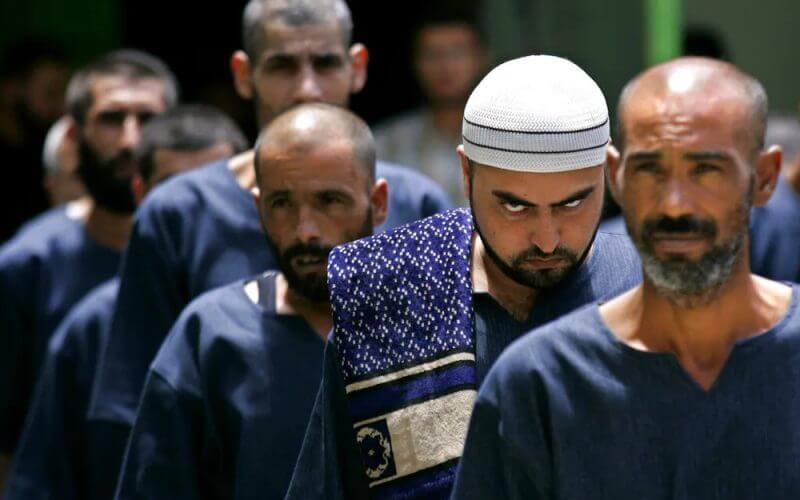 Palestinian prisoners line up at the Hamas-controlled Saraya prison in Gaza City, Gaza. AP Photo/Kevin Frayer, File