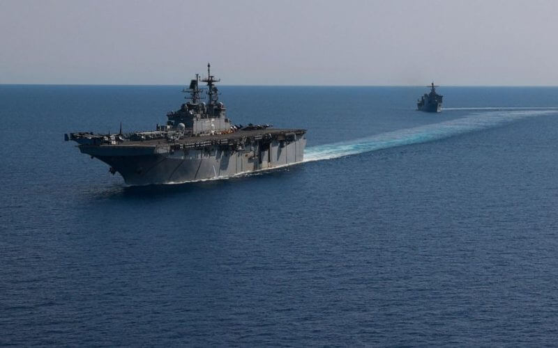 In this photo released by the U.S. Navy, the amphibious assault ship USS Bataan, front, and the landing ship USS Carter Hall, back travel through the Red Sea, Tuesday, Aug. 8, 2023. (Mass Communication Specialist 3rd Class Riley Gasdia/U.S. Navy, via AP)