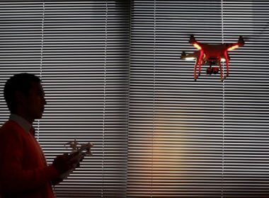 A staff member from DJI Technology Co. demonstrates the remote flying with his Phantom 2 Vision+ drone inside his office in Shenzhen, south China's Guangdong province, on Dec. 15, 2014. (AP Photo/Kin Cheung, File)