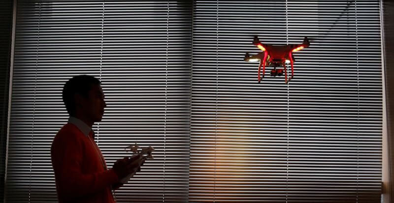 A staff member from DJI Technology Co. demonstrates the remote flying with his Phantom 2 Vision+ drone inside his office in Shenzhen, south China's Guangdong province, on Dec. 15, 2014. (AP Photo/Kin Cheung, File)