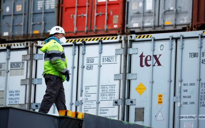 A dockworker wearing a mask is seen near containers as he works at port in Ashdod, Israel March 18, 2020. REUTERS