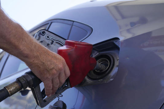 A customer pumps gas at an Exxon gas station, Tuesday, May 10, 2022, in Miami. Marta Lavandier AP