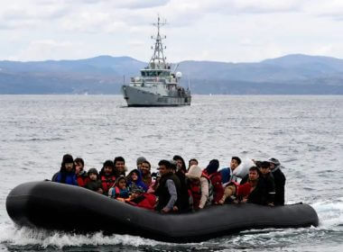 Refugees and migrants arrive in a dinghy accompanied by Frontex vessels at the village of Skala Sikaminias, on the Greek island of Lesbos, after crossing the Aegean sea from Turkey, on Feb. 28, 2020. (Michael Varaklas/AP Photo)