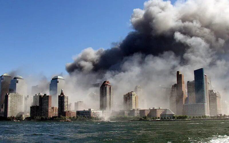Smoke rises over the New York Skyline from the scene of the World Trade Center Attack, as seen from a tugboat evacuating people from Manhattan to New Jersey. (Photo by Hiro Oshima/WireImage)