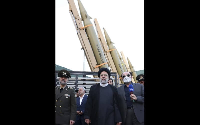 In this photo released by the Iranian Presidency Office, President Ebrahim Raisi, center, attends a ceremony to deliver the domestically built missiles to the armed forces as his Defense Minister Mohammad Reza Gharaei Ashtiani, left, Iran, on Aug. 22, 2023. (Iranian Presidency Office, via AP, File)