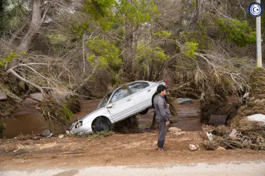 In this photo provided by the Libyan government, a car sits partly suspended in trees after being carried by floodwaters in Derna, Libya, on Monday, Sept. 11, 2023. (Libyan government handout via AP)