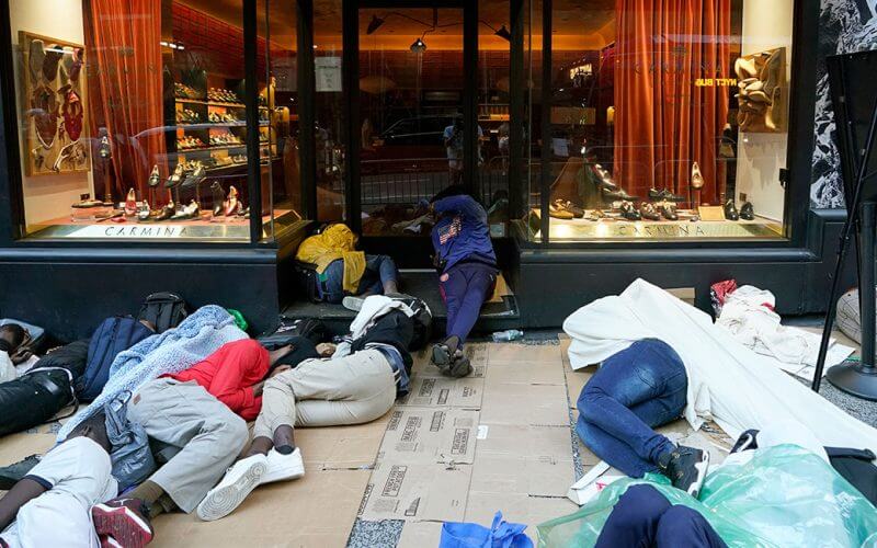 Illegal aliens sleep outside the Roosevelt Hotel on Aug. 1 as they wait for placement in the hotel in New York City. (Photo: Timothy Clary/AFP/Getty Images)