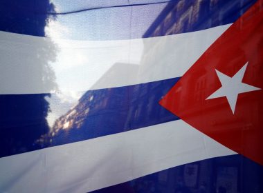 The silhouette of the city is seen through a Cuban flag during a protest against the U.S. economic embargo in Cuba, in Madrid, Spain, July 26, 2021. REUTERS