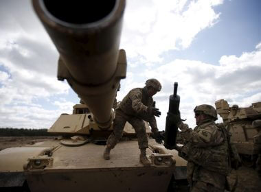 Members of the U.S. 2nd Battalion, 7th Infantry Regiment, 1st Brigade Combat Team, 3rd Infantry Division get ammunition to the Abrams tank during an exercise at Mielno range near Drawsko-Pomorskie April 16, 2015. REUTERS