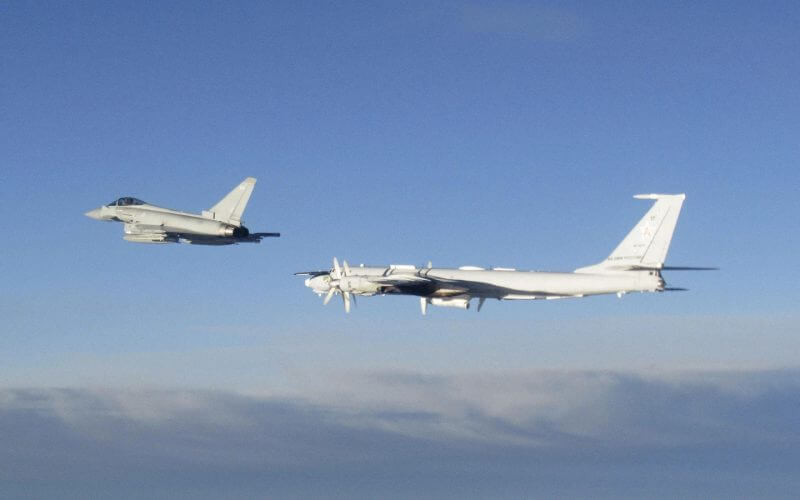 In this photo issued on Monday Aug. 14, 2023 by the Ministry of Defence (MoD), an RAF Typhoon, left, monitors a Russian Tupolev Tu-142 maritime reconnaissance and anti-submarine warfare (ASW) aircraft. AP
